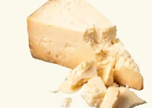 Pieces of Sharp Cheddar cheese on white background