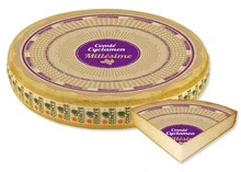A wheel of Comté Cyclamen Millésime 24 Month cheese with a label, and a labeled triangular slice are displayed against a white background.