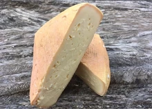 Slices of Highmoor cheese arranged on a wooden surface