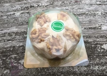 Rambol cheese packet showing crunchy walnuts sits on a wooden surface