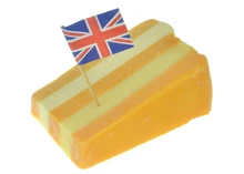 A wedge of Five Counties cheese with UK flag set against white background