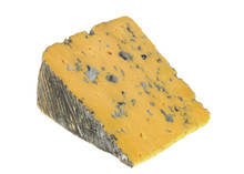 A wedge of Blacksticks Blue cheese, showcasing its soft amber-hued interior with blue veins running throughout, set against a white background.