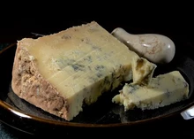 Slices of Dorset Blue Vinny cheese on a black plate