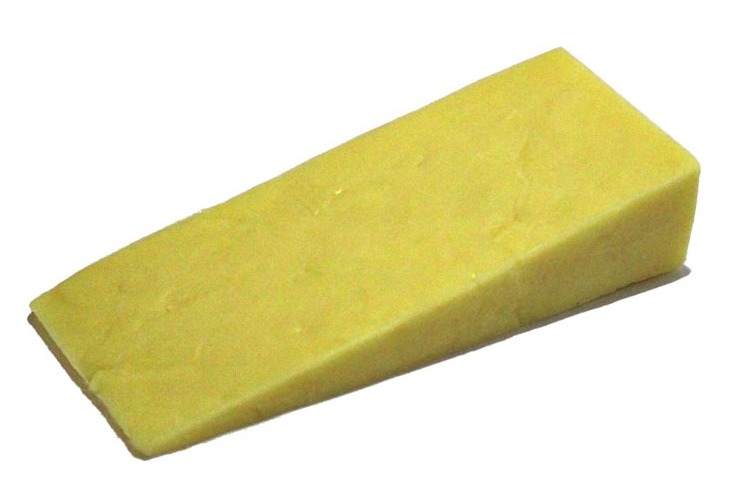 A slice of Farmhouse Mature Cheddar cheese placed against a white background.